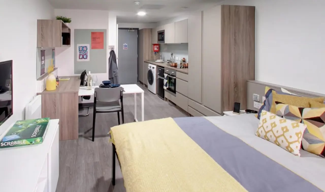 Bed kitchen study area and washing machine bedroom at Sycamore House in Leeds Student Accommodation